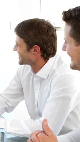 Smiling-colleagues-speaking-during-a-meeting