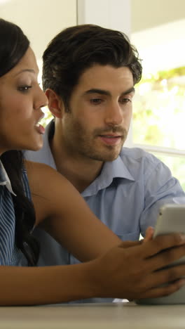 Couple-interacting-with-each-other-while-using-digital-tablet