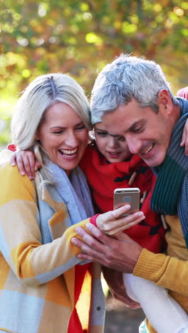 Parents-and-son-taking-a-selfie-on-mobile-phone-