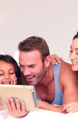 Happy-family-using-tablet