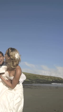 Smiling-newlyweds-running-to-the-camera-on-the-beach