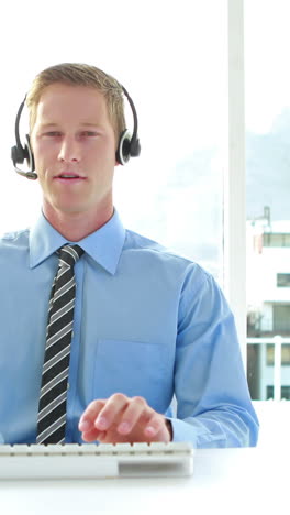 Businessman-having-a-phone-call-with-headset-in-call-center