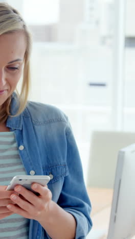 Businesswoman-text-messaging-on-mobile-phone