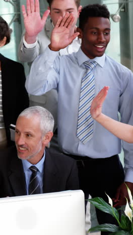 Business-people-giving-a-high-five-to-each-other