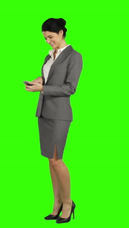 Business-woman-laughing-while-using-a-smartphone-and-looking-at-the-camera