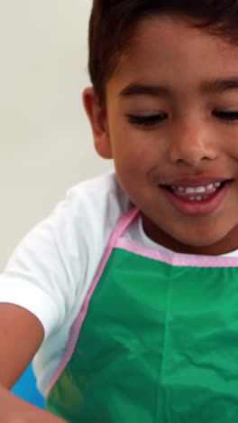 Cute-little-boys-painting-at-table-in-classroom