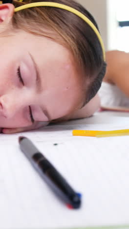 School-kids-sleeping-on-desk-in-classroom