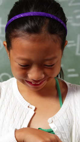 Schoolgirl-using-digital-tablet-in-classroom-at-school