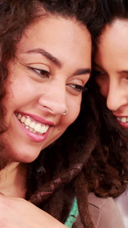 Smiling-lesbian-couple-posing-together-in-the-kitchen