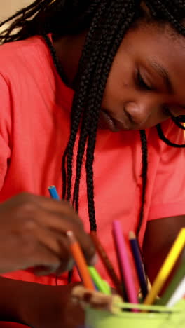 Preschool-class-drawing-at-table-in-classroom