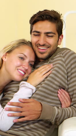 Cute-happy-couple-resting-together-on-the-couch