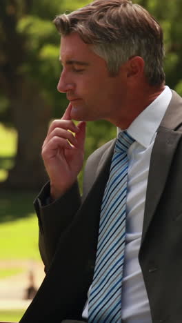 Thoughtful-businessman-in-the-park