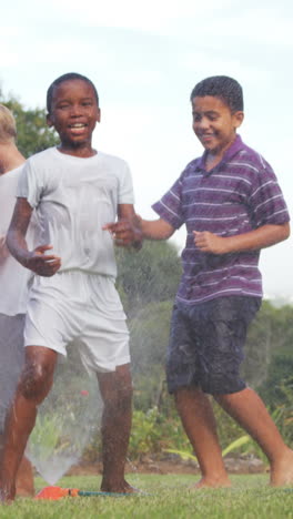 Kids-playing-with-garden-sprinkler