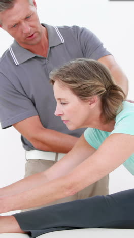 Woman-putting-her-foot-on-a-table-while-stretching-her-leg