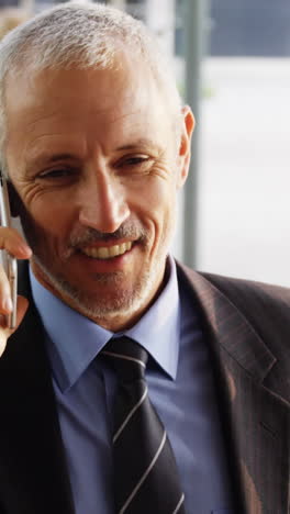 Businessman-talking-on-mobile-phone