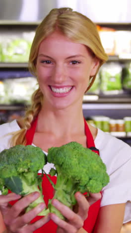 Female-staff-checking-vegetables-in-organic-section