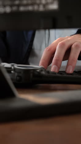 Security-guard-receiving-call-while-working-on-computer