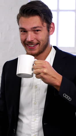 Handsome-businessman-having-a-coffee-break