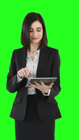 Business-woman-standing-and-using-a-tablet