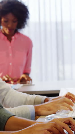 Businesswoman-working-on-laptop-at-desk