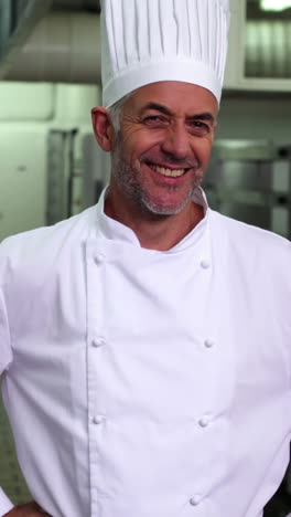 Head-chef-smiling-at-camera-with-hands-on-hips