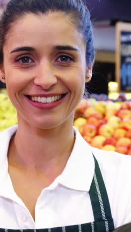 Female-staff-holding-barcode-scanner-in-organic-section