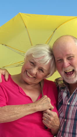 Senior-couple-holding-umbrella