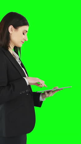 Business-woman-standing-and-using-a-tablet