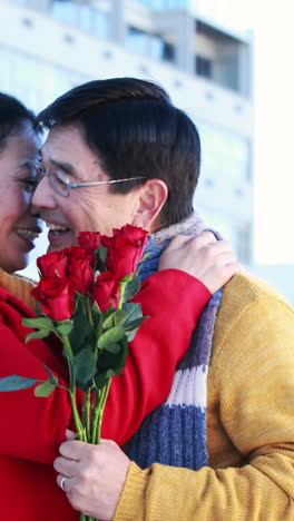 Asian-man-giving-roses-to-his-wife