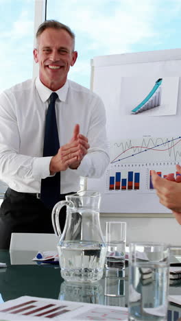 Business-manager-applauding-his-staff-at-meeting