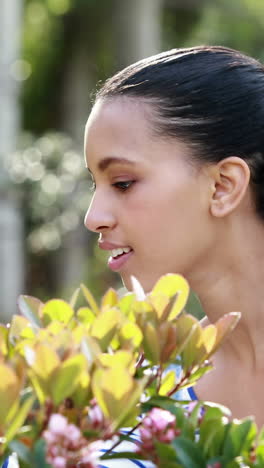 Pretty-girl-looking-at-flowers