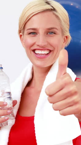 Blonde-woman-drinking-water-with-thumbs-up-