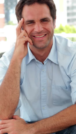 Smiling-man-sitting-on-the-sofa