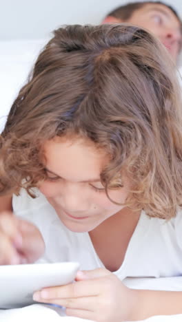 Children-playing-with-tablet-while-parents-talking