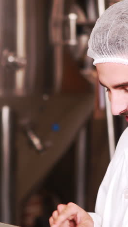 Smiling-brewery-worker-using-tablet