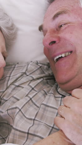 Senior-couple-smiling-in-bed