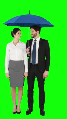 Business-people-standing-under-umbrella