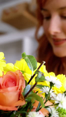 Female-florist-smelling-flower