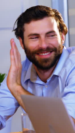 Business-executives-applauding-a-colleague-after-presentation