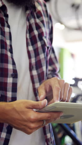 Mechanic-using-digital-tablet-in-workshop