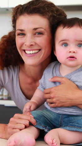 Happy-mother-sitting-with-her-baby-boy