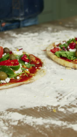 Close-up-view-of-a-couple-preparing-pizza