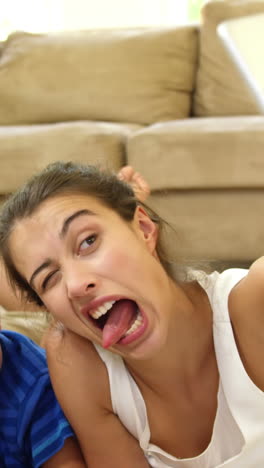 Happy-family-lying-on-carpet-taking-a-selfie