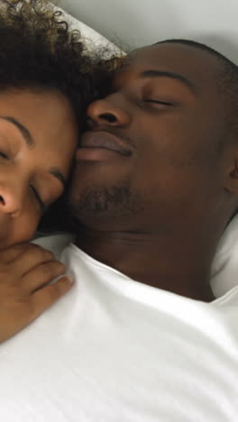 Young-couple-sleeping-together-on-bed