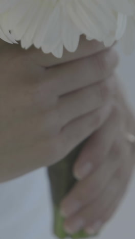 Beautiful-bride-holding-bouquet-of-daisies-