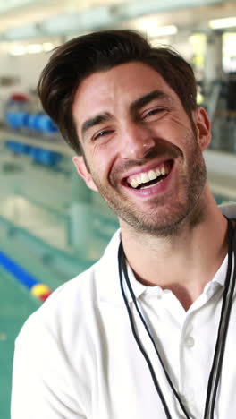 Smiling-trainer-posing-by-the-pool