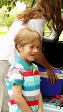 Family-unloading-their-car-for-a-camping-trip