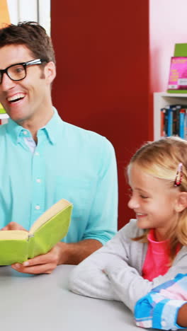 Teacher-reading-book-in-library