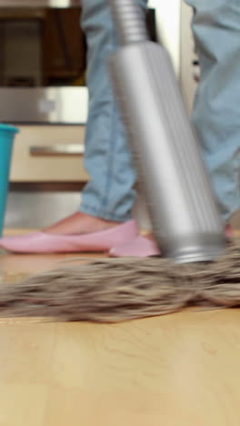 Woman-cleaning-her-kitchen-floor