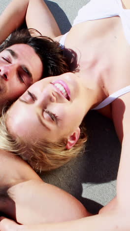 Couple-relaxing-together-on-beach